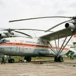 Mil V-12 Homer dual-rotor experimental helicopter parked outside aviation museum
