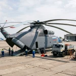 Mil Mi-26 heavy lift transport helicopter parked outside hangar on concrete apron