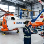 Avionics engineers analyzing helicopter flight telemetry data in modern hangar