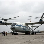 Mil V-12 Homer experimental giant helicopter on airfield with massive transverse rotors